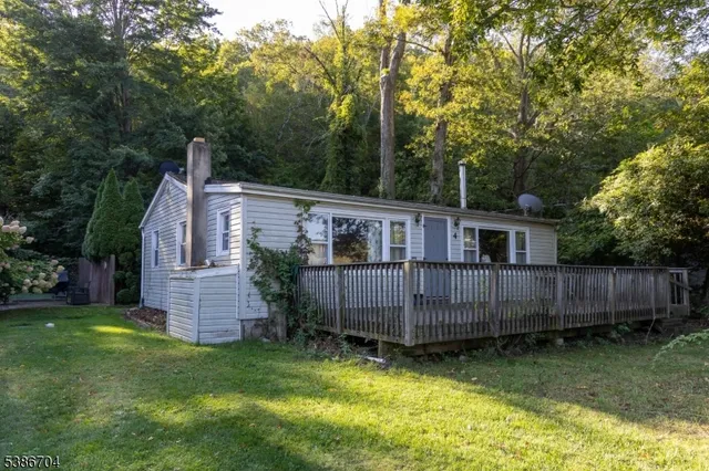 a view of a yard in front of a house with a large trees