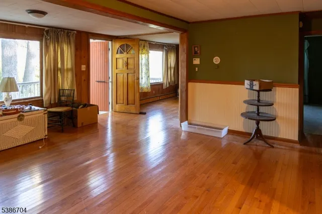 a view of a livingroom with furniture hardwood floor and windows