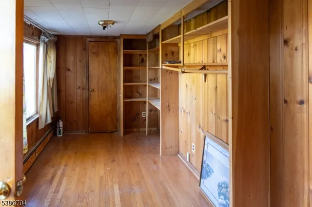 a view of walk in closet with wooden floor