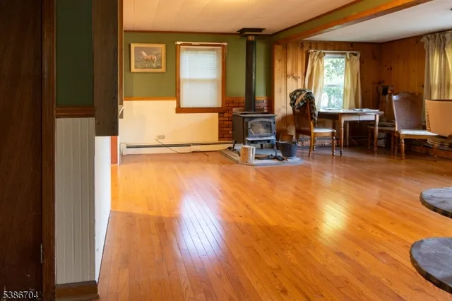 a view of a workspace with wooden floor and a window