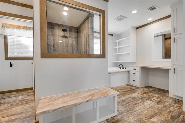 a room with a bed and cabinets