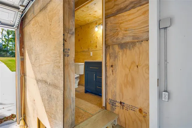 a bathroom with a glass shower door and a bathroom