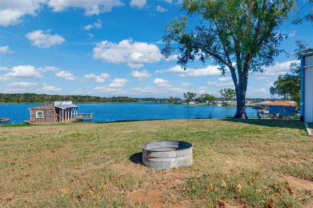 a view of a lake with houses in the back