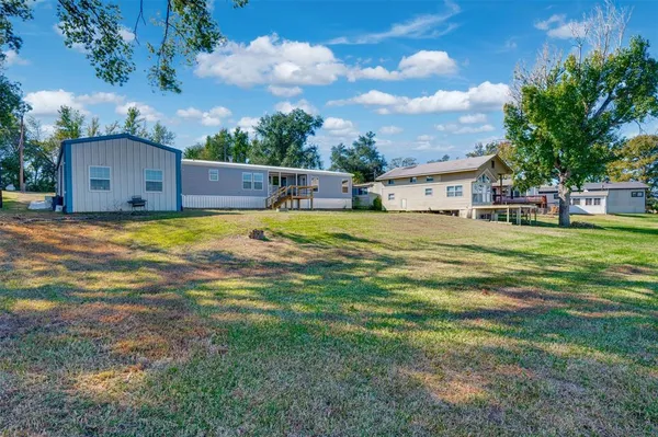 a swimming pool is sitting in a yard with wooden fence