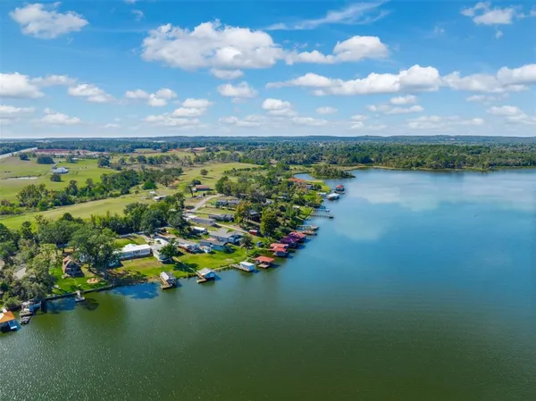 a view of a lake in middle of forest