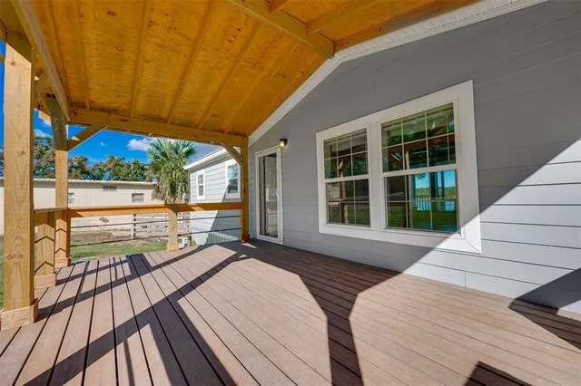 a balcony with furniture and a large window