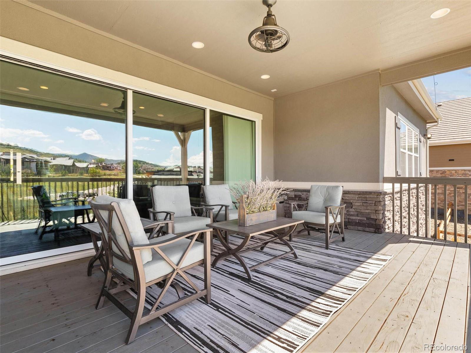 14916 Lyons Ridge Drive Morrison, CO 80465 - Photo 24 of 29 a building outdoor space with patio furniture and wooden floor