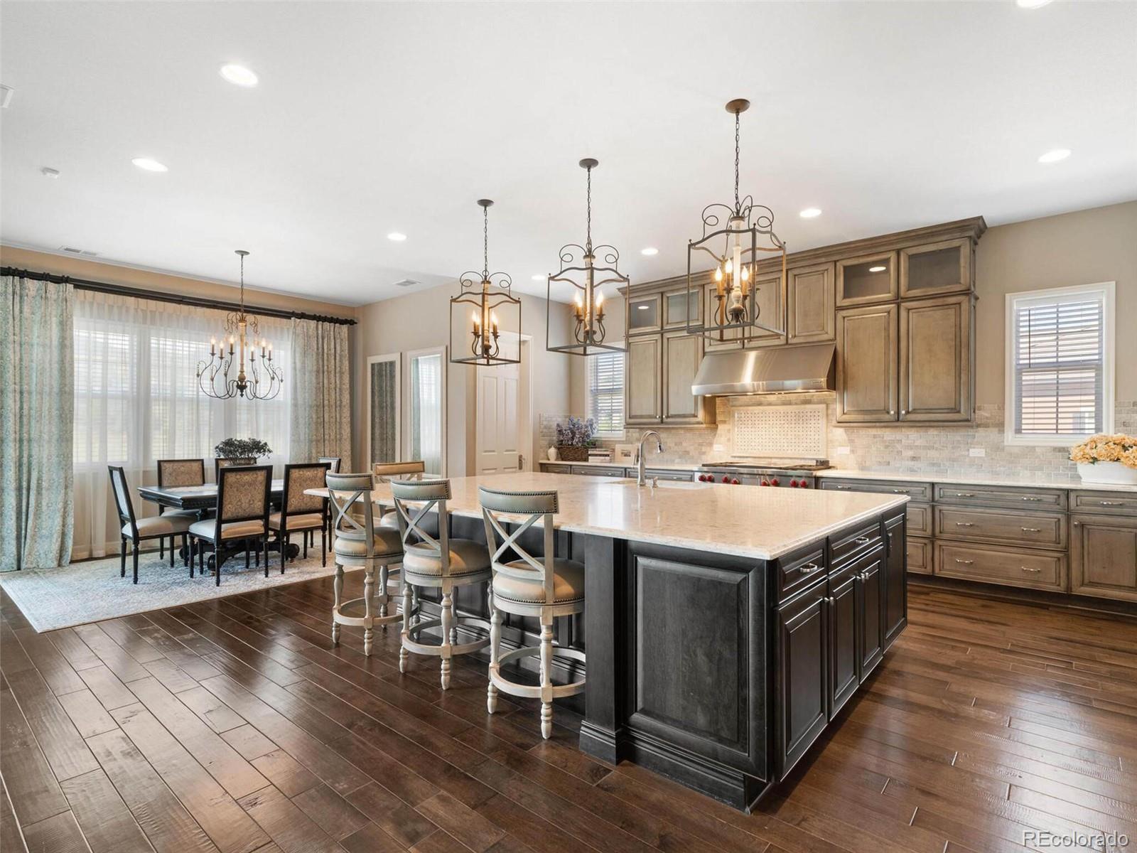 14916 Lyons Ridge Drive Morrison, CO 80465 - Photo 8 of 29 a large kitchen with lots of counter space and dining table