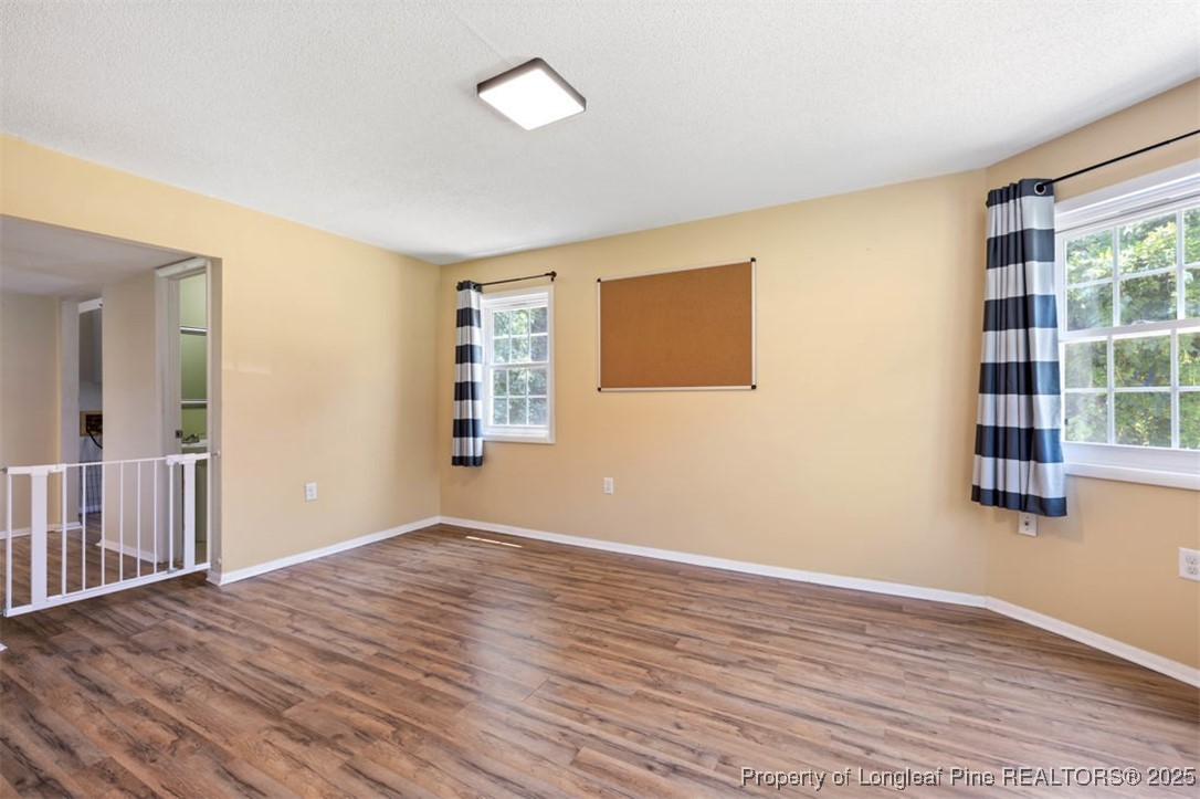2040 Page Road Stedman, NC 28391 - Photo 12 of 33 a view of an empty room with wooden floor and a window