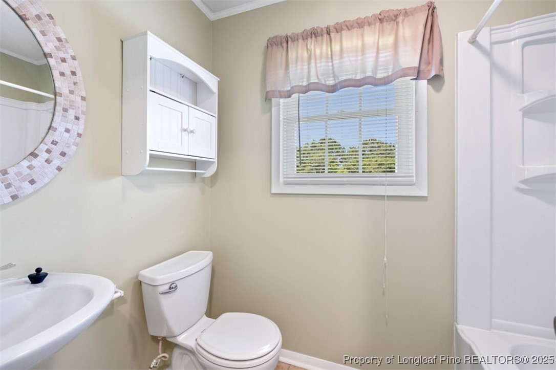 2040 Page Road Stedman, NC 28391 - Photo 19 of 33 a white toilet sitting next to a bathroom sink