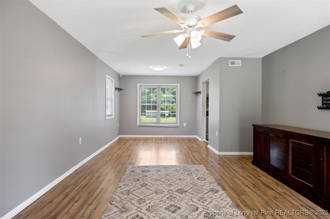 2040 Page Road Stedman, NC 28391 - Photo 3 of 33 wooden floor in an empty room with a window