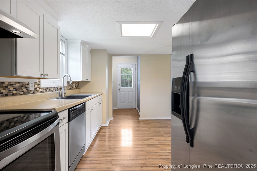 2040 Page Road Stedman, NC 28391 - Photo 5 of 33 a kitchen with stainless steel appliances a refrigerator sink and stove