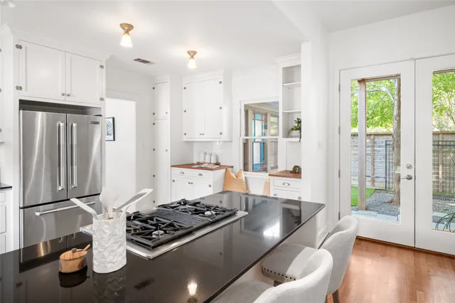 a kitchen with stainless steel appliances granite countertop a stove and a refrigerator