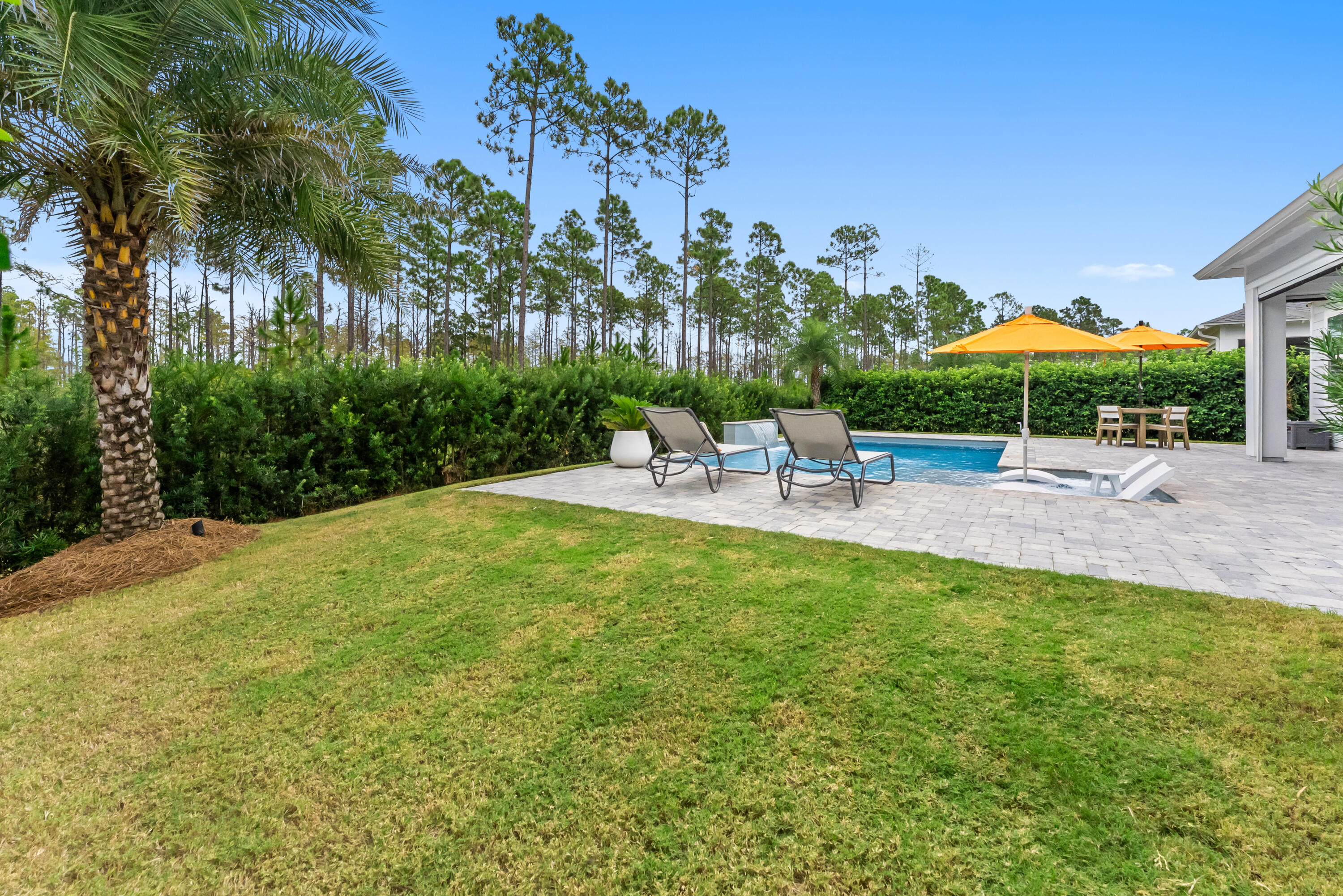 320 West Lafayette Rd Inlet Beach Inlet Beach, FL 32461 - Photo 57 of 90 a view of a backyard with table and chairs under an umbrella with palm trees