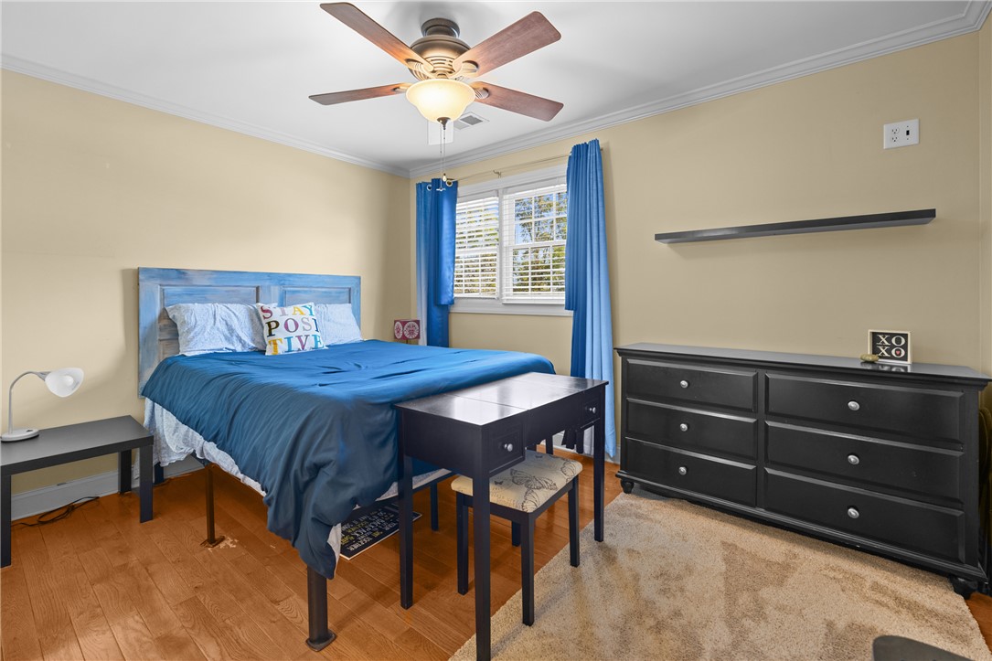 209 Calhoun Street, Unit 201 Clemson, SC 29631 - Photo 18 of 35 This inviting bedroom features rich hardwood flooring and a functional ceiling fan for comfort.