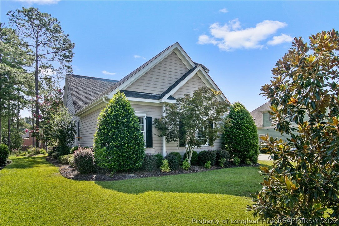 254 Falling Water Road Spring Lake, NC 28390 - Photo 3 of 35 a front view of a house with a yard and potted plants