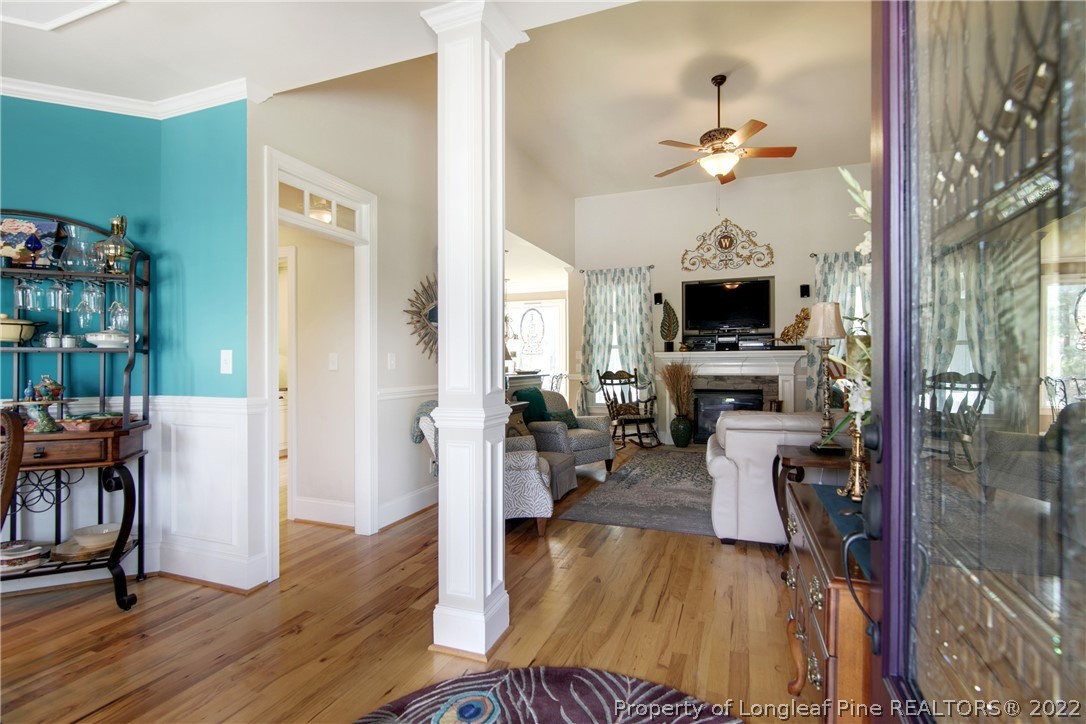 254 Falling Water Road Spring Lake, NC 28390 - Photo 5 of 35 a view of a livingroom with furniture a flat screen tv and wooden floor