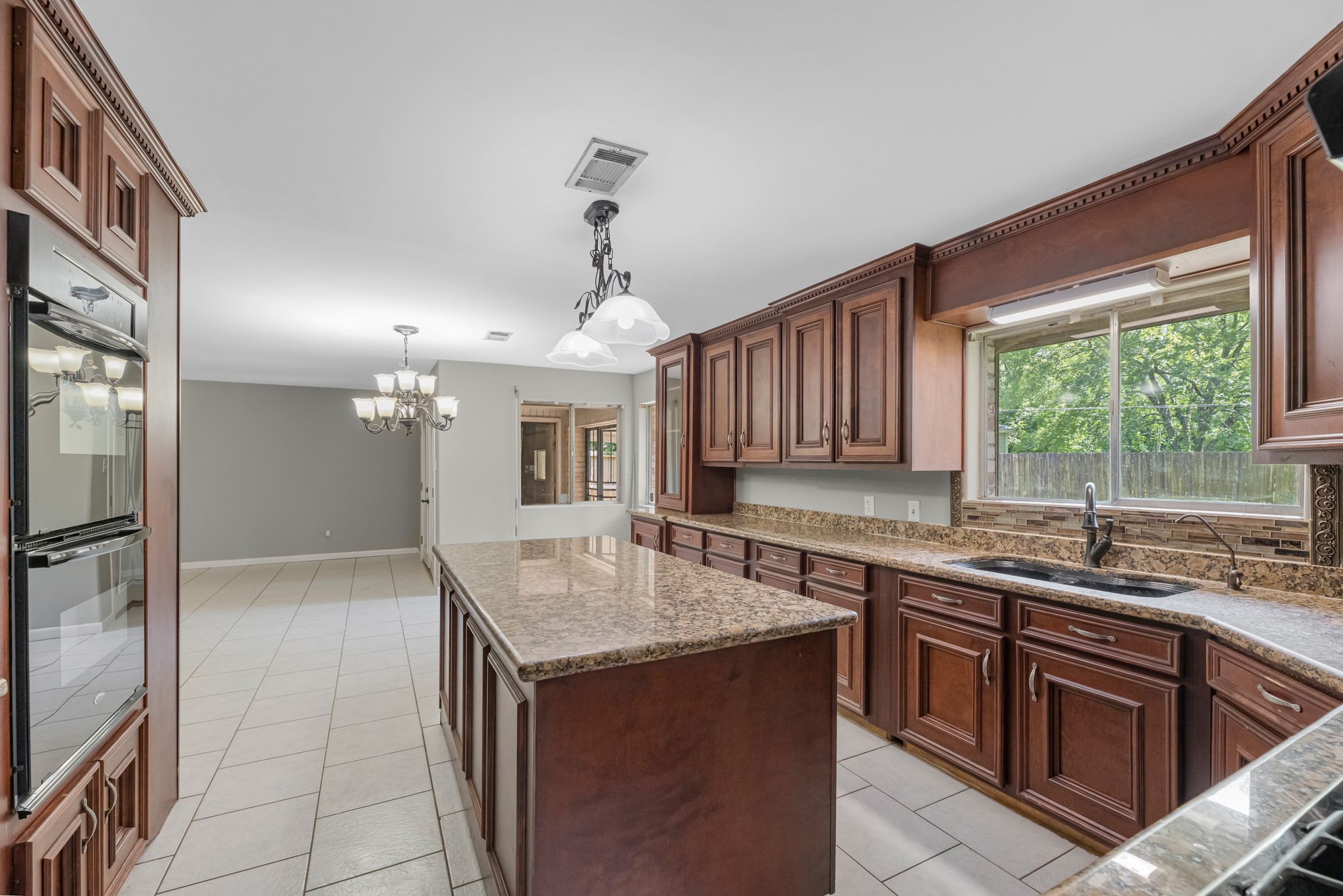 1109 Becker Street Channelview, TX 77530 - Photo 11 of 43 a kitchen with a sink refrigerator and cabinets