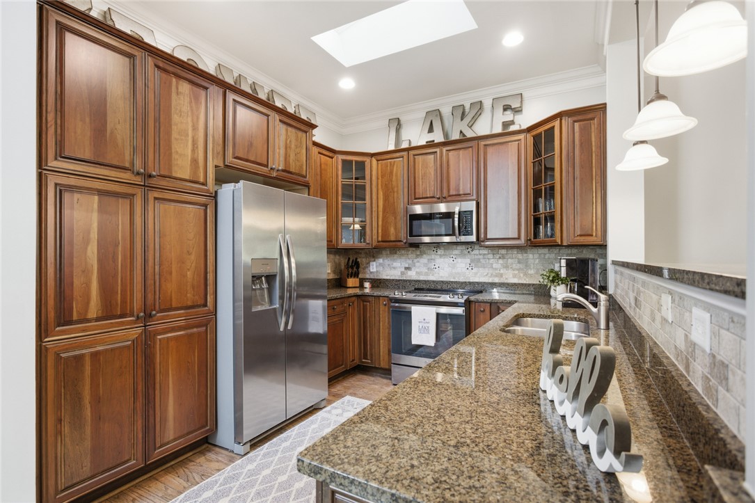578 Sunset Point Drive West Union, SC 29696 - Photo 4 of 46 This spacious kitchen offers ample storage, modern appliances, and generous counter space for culinary endeavors.