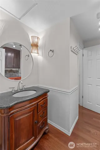 a utility room with cabinets and wooden floor