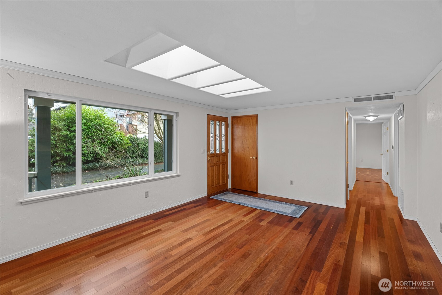 1306 Southwest 160th Street Burien, WA 98166 - Photo 4 of 29 a view of an empty room with wooden floor and a window