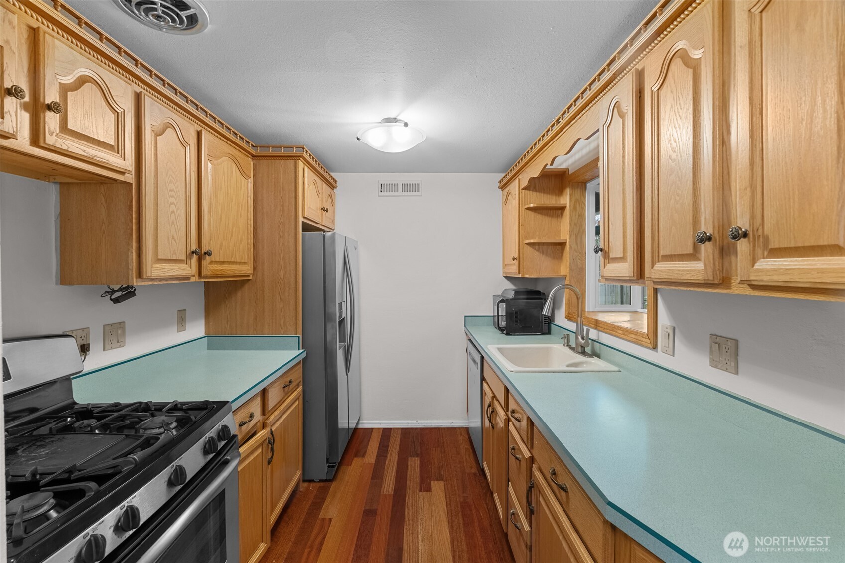 1306 Southwest 160th Street Burien, WA 98166 - Photo 8 of 29 a kitchen with stainless steel appliances granite countertop a stove and a sink