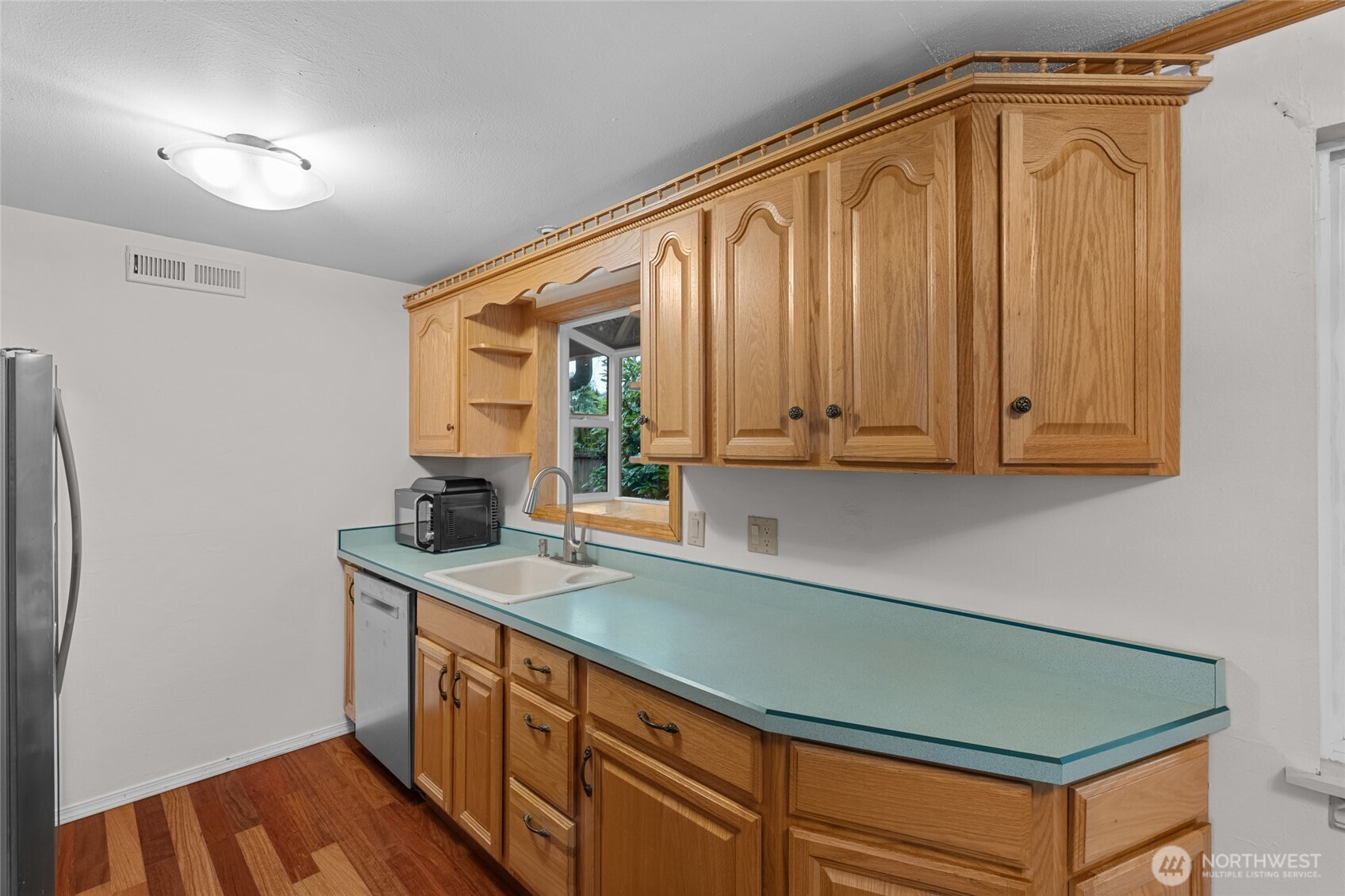 1306 Southwest 160th Street Burien, WA 98166 - Photo 9 of 29 a utility room with stainless steel appliances granite countertop a sink a washer and dryer with wooden floor