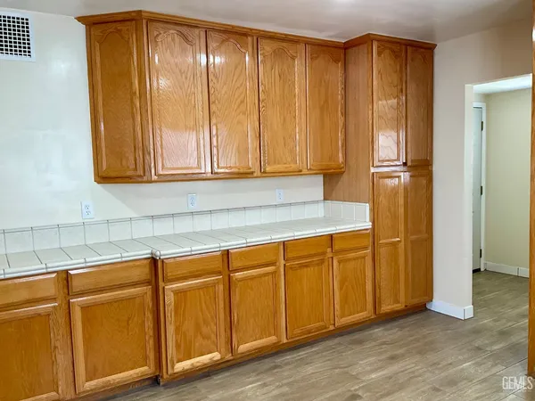 a view of a kitchen with wooden cabinets
