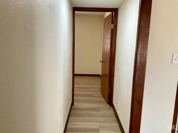 a view of a hallway with wooden floor