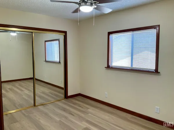 a view of a room with wooden floor and cabinet