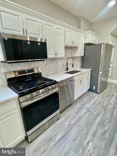 4041 West Cold Spring Lane Baltimore, MD 21215 - Photo 11 of 37 a kitchen with stainless steel appliances a stove a microwave and sink