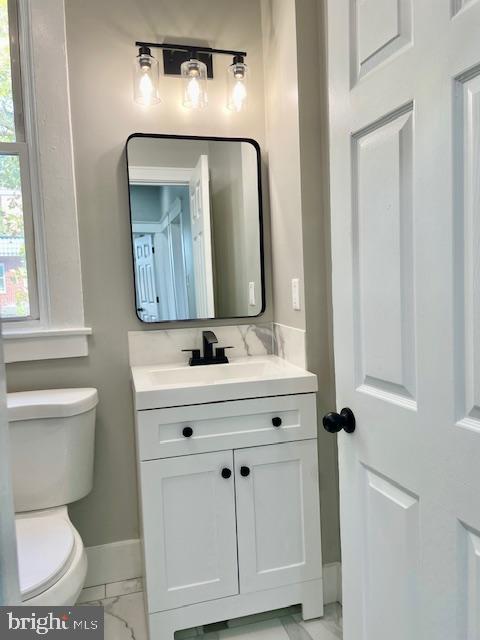 4041 West Cold Spring Lane Baltimore, MD 21215 - Photo 21 of 37 a bathroom with a toilet sink and mirror