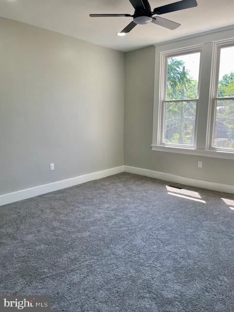 4041 West Cold Spring Lane Baltimore, MD 21215 - Photo 22 of 37 an empty room with a ceiling fan and window