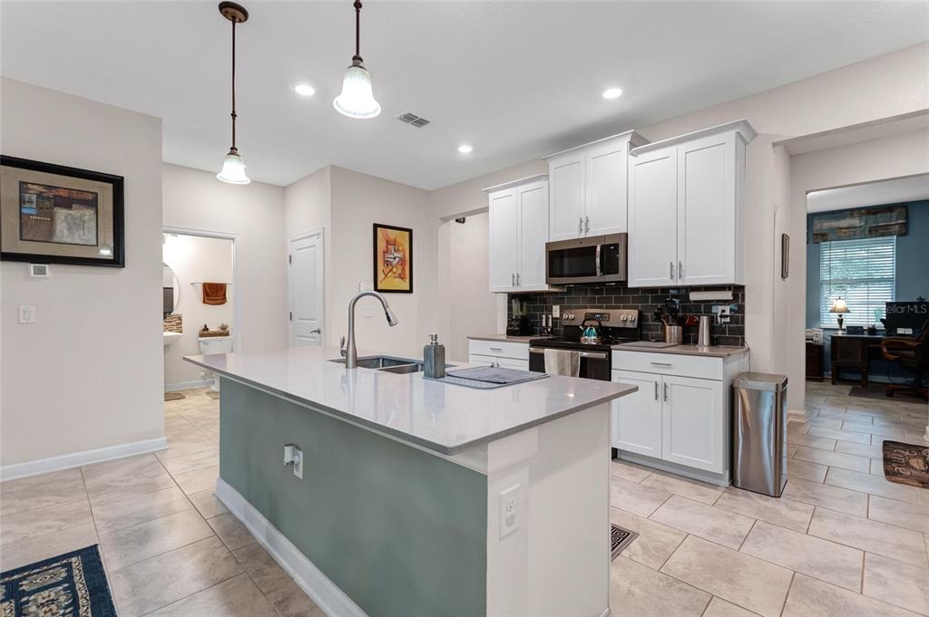 1089 Blackwolf Run Road Davenport, FL 33896 - Photo 10 of 82 a kitchen with a sink a counter top space appliances and cabinets