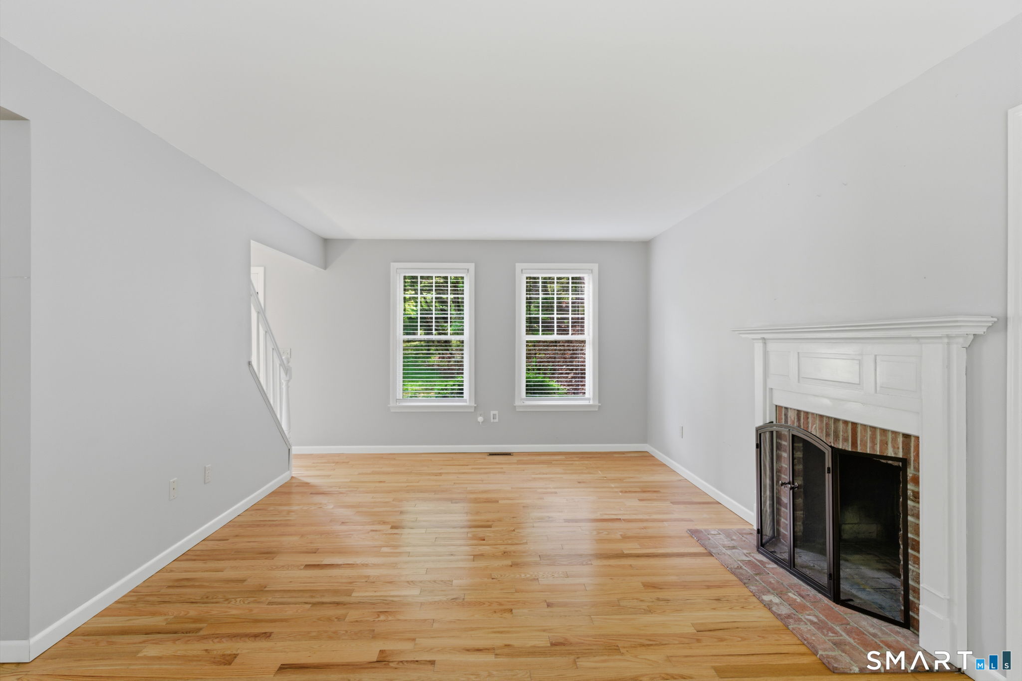 21 Greenwood Road North Granby, CT 06060 - Photo 4 of 40 a view of empty room with wooden floor and fireplace