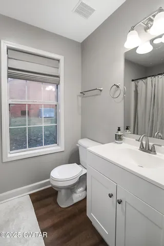 a view of room with furniture and wooden floor