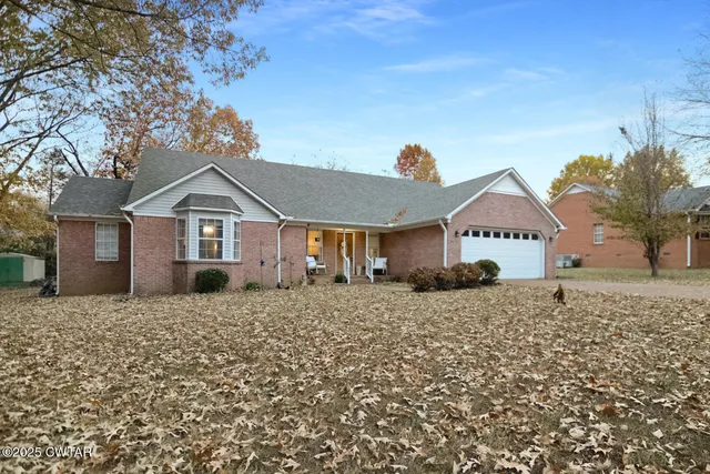 front view of a house with a bench