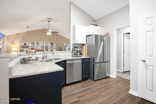 a kitchen with a sink refrigerator and microwave