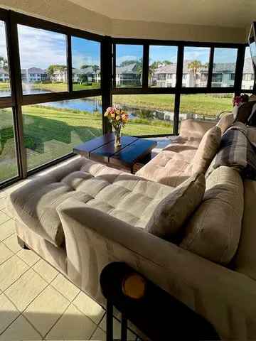 a living room with large window and a table