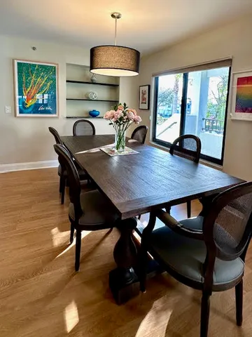a view of a dining room with furniture window and wooden floor