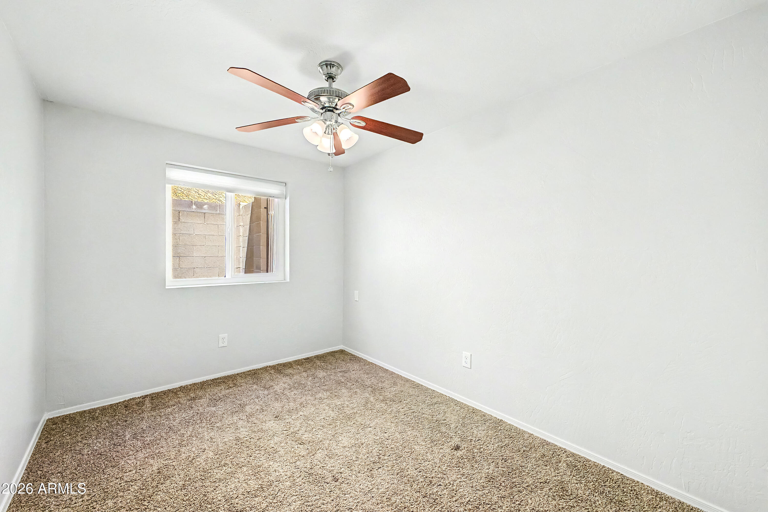 3134 East McKellips Road, Unit 221 Mesa, AZ 85213 - Photo 16 of 29 an empty room with windows and fan