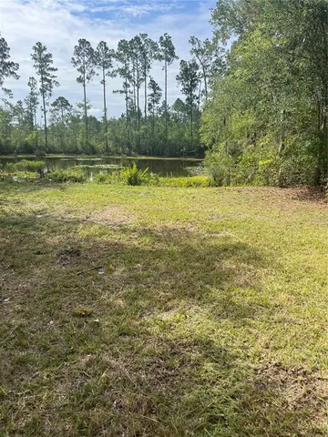 a view of a lake with houses in the back