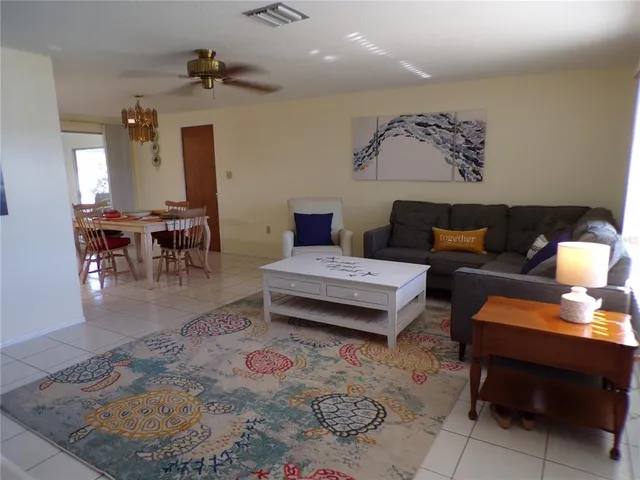a living room with furniture and a dining table