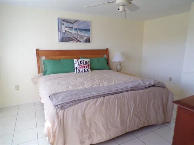 a bed sitting in a bedroom next to a wall