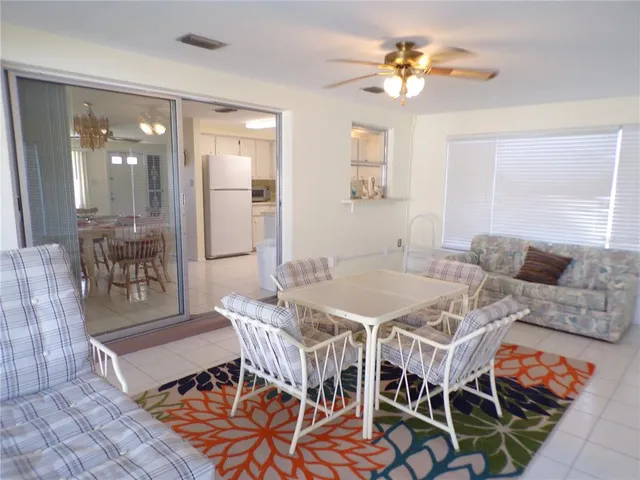 a dining room with furniture and a chandelier