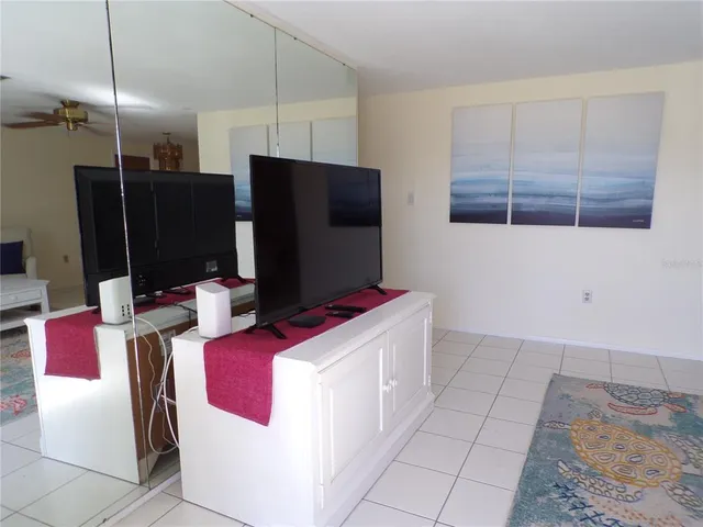 a kitchen with stainless steel appliances kitchen island granite countertop a refrigerator and a stove