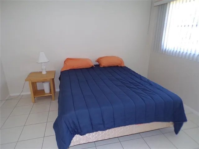 a bed sitting in a room next to a window