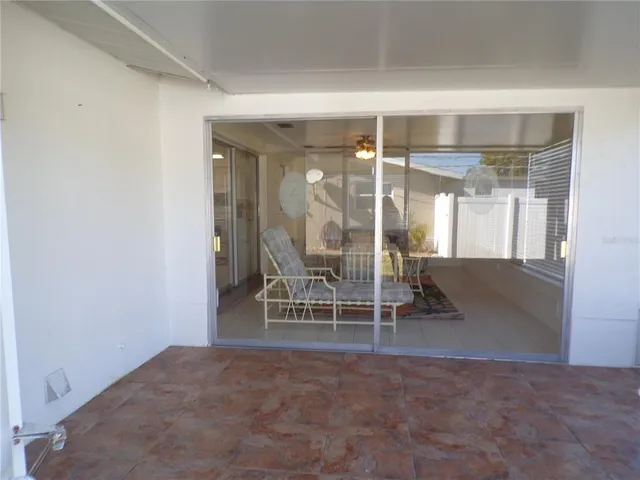 a view of a room with wooden floor and windows