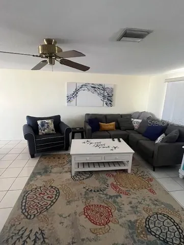 a living room with furniture and a rug