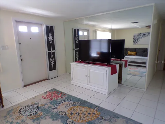 a kitchen with stainless steel appliances kitchen island granite countertop a refrigerator and microwave